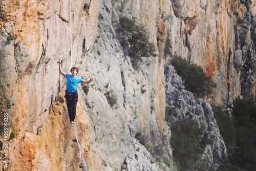 Man balancing on the rope concept of risk taking and challenge.