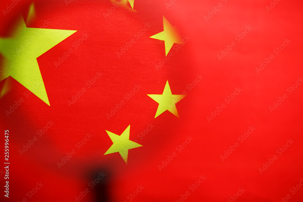 The flag of the CHINESE PEOPLE'S REPUBLIC is looking through a magnifying glass. The study of the history and culture of a large country and the people of China. The concept of studying the geography The flag of the CHINESE PEOPLE'S REPUBLIC is looking through a magnifying glass. The study of the history and culture of a large country and the people of China. The concept of studying the geography