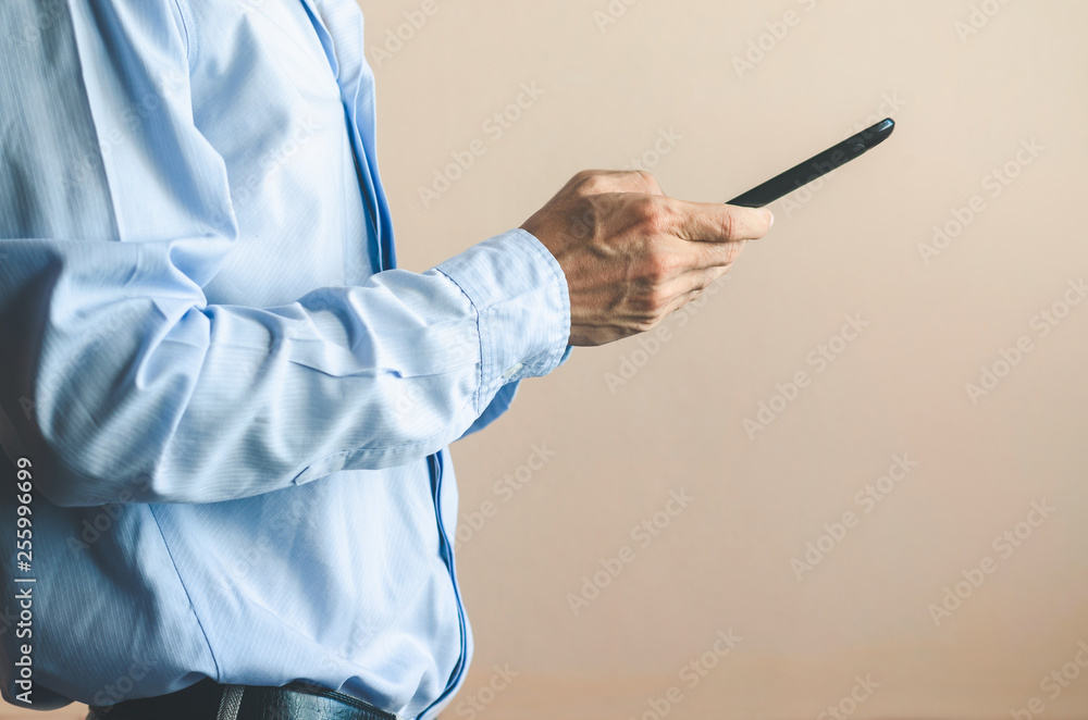 businessman using mobile phone touching screen in office with hands typing smart phone texting messaging lifestyle working app device technology internet social data online concept vintage style.