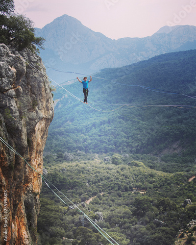 Man balancing on the rope concept of risk taking and challenge.