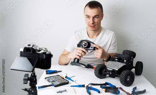 The guy keeps a video blog about radio controlled car models. On the table are tools for repair.