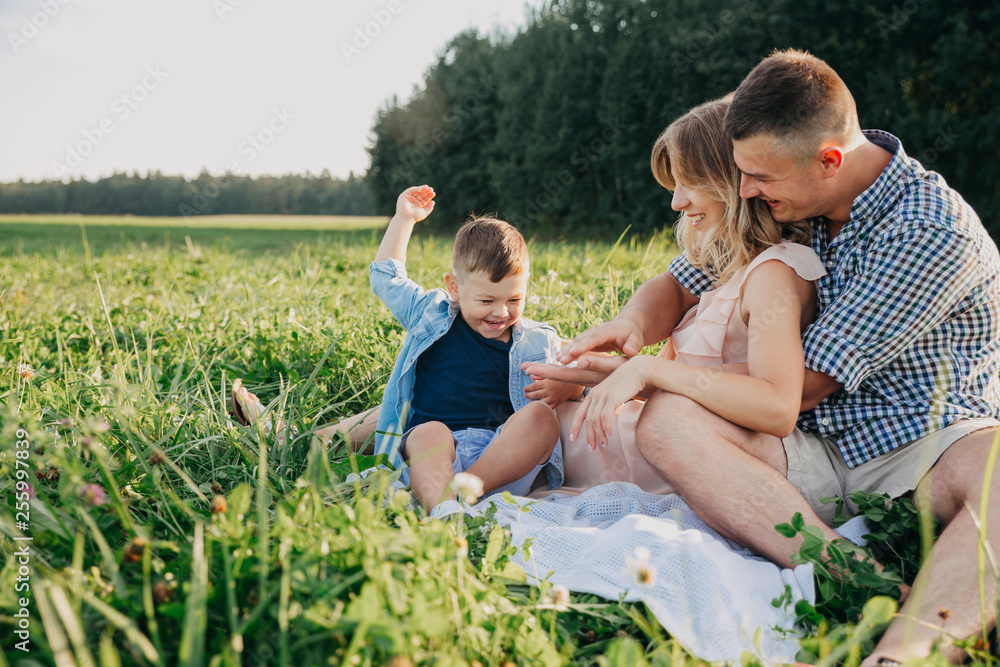 Fototapeta premium Parents and little son on vacation playing together