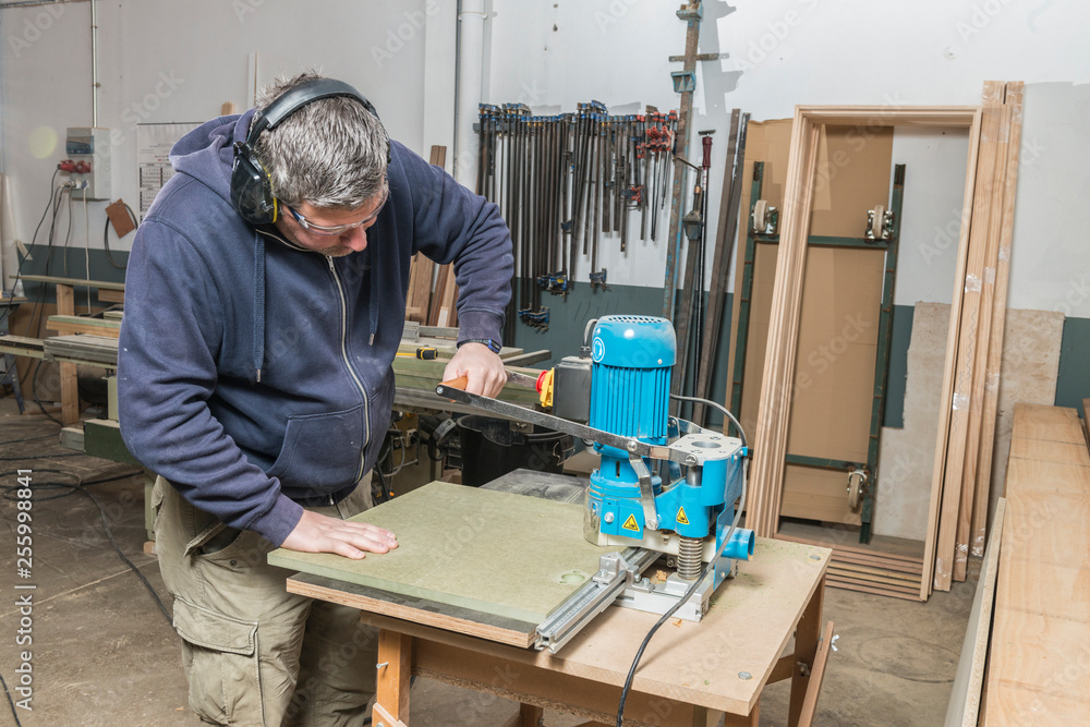 Male carpenter working in his carpentry workshop. Male carpenter working in his carpentry workshop.