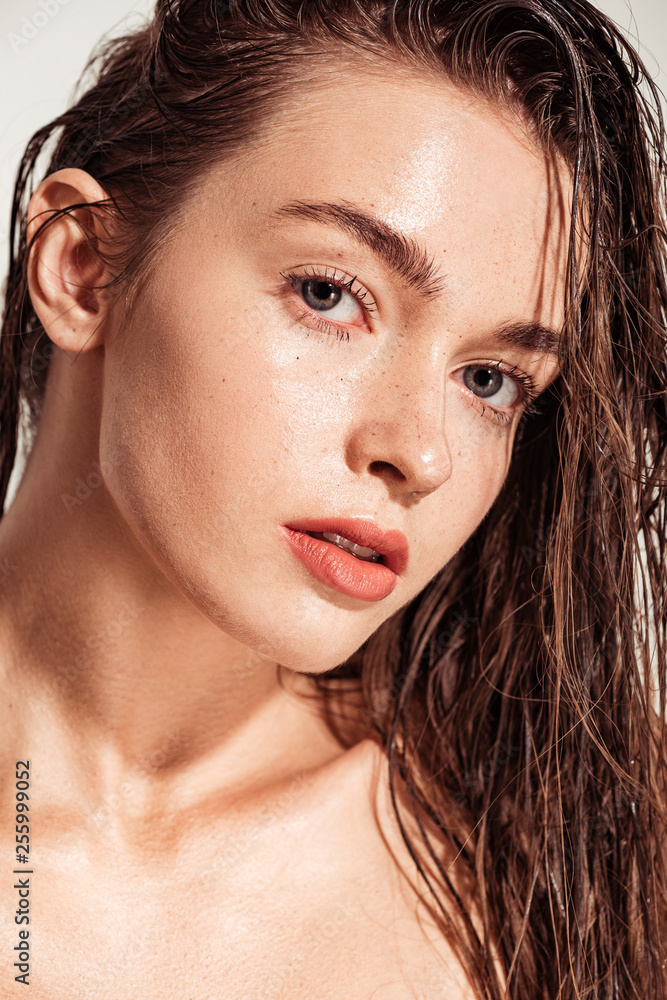 beautiful young woman with coral lips and wet hair looking at camera - obrazy, fototapety, plakaty 
