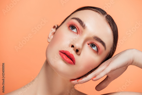 beautiful stylish young woman posing isolated on coral