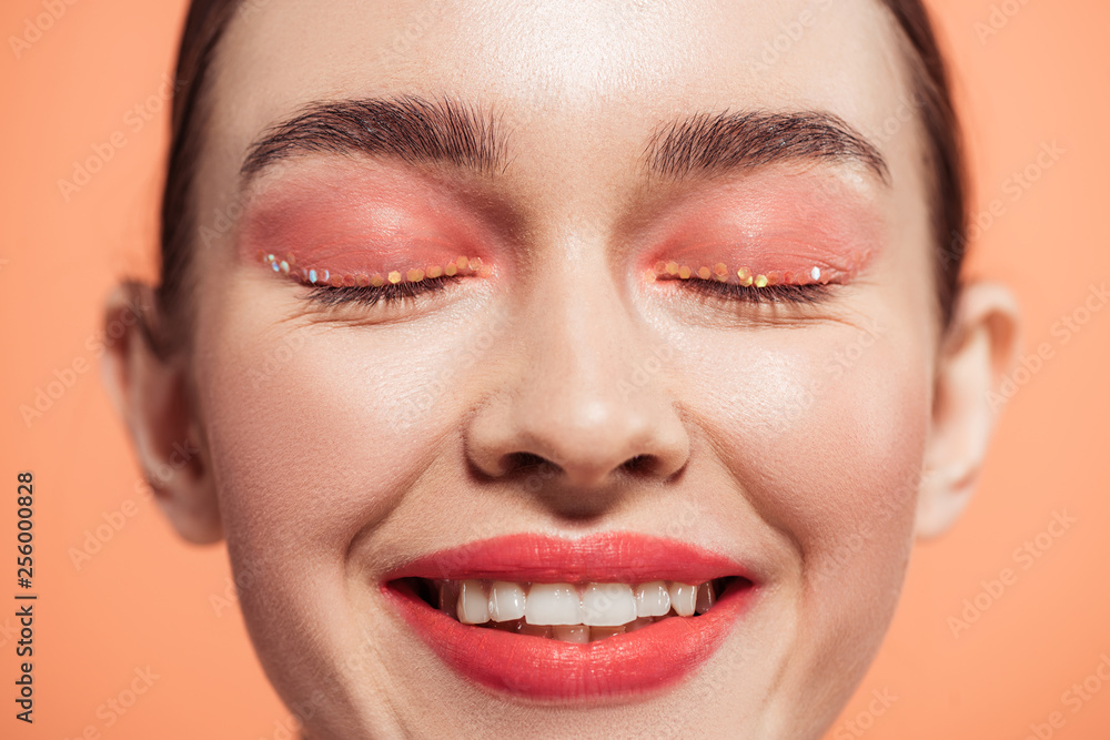 beautiful smiling stylish young woman posing isolated on coral beautiful smiling stylish young woman posing isolated on coral