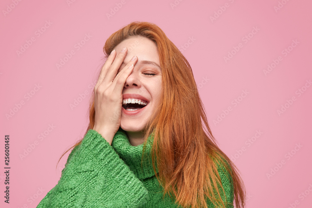 Laughing model with hand on face