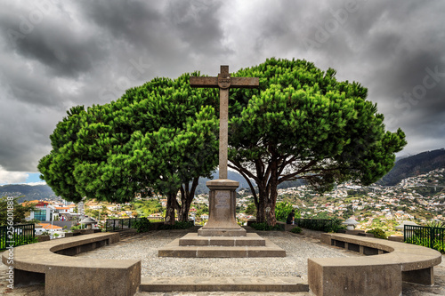 Beautiful ominous view of the monument cross on top of the Barcelos viewpoint (Miradouro Pico dos Barcelos) in Funchal, Madeira photo