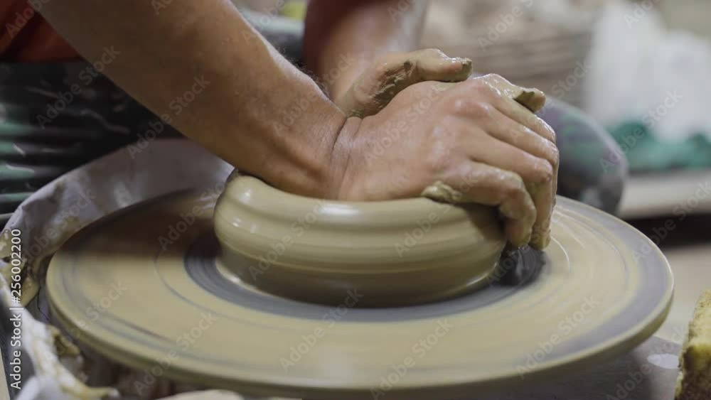 Potter hands working and making pottery. Potter hands working and making pottery.