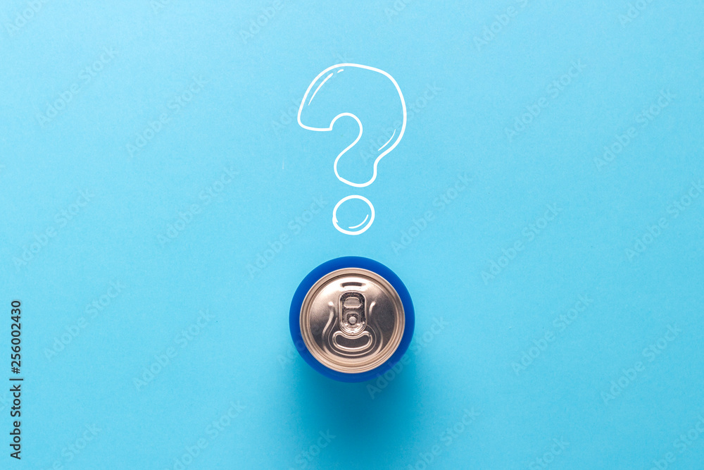 Tin can with a drink on a blue background with a question mark. minimalism. Concept of an unknown drink, try the first time Flat lay, top view.