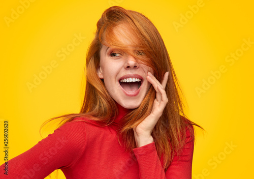 Charming ginger girl in red turtleneck