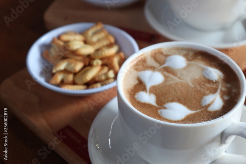 Coffee cup with latte art foam on wood table in coffee shop with copy space.Coffee is one of the most popular beverages.Improve Energy Levels and Burn Fat