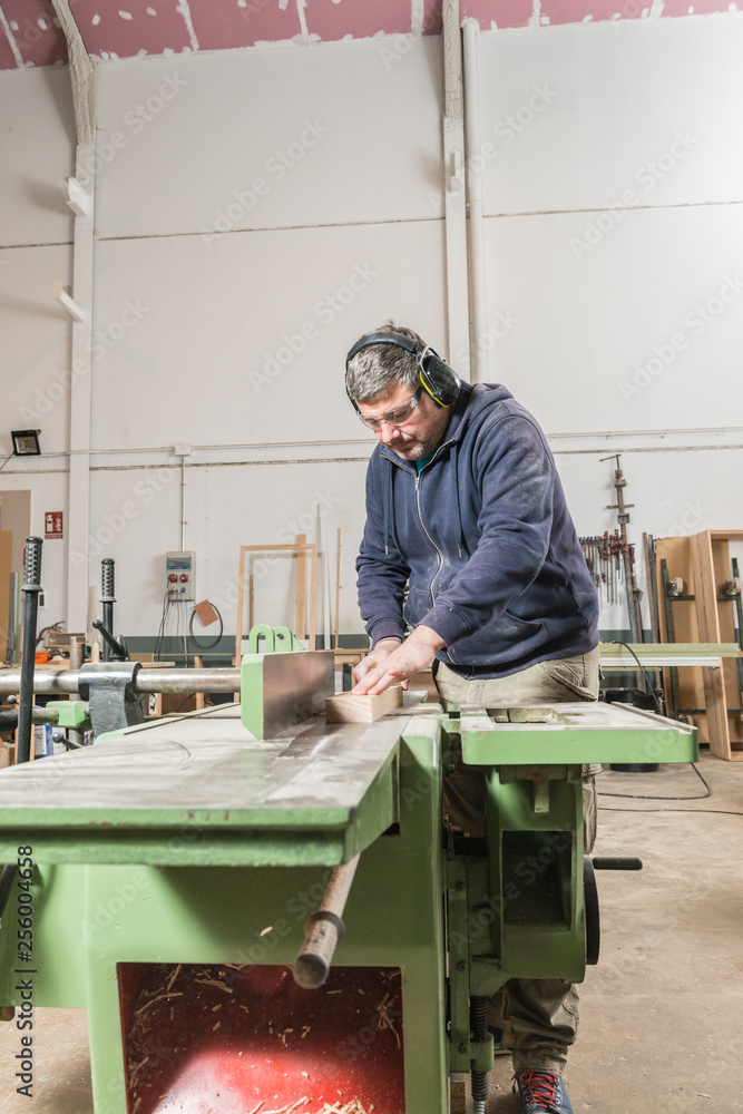 Male carpenter working in his carpentry workshop.