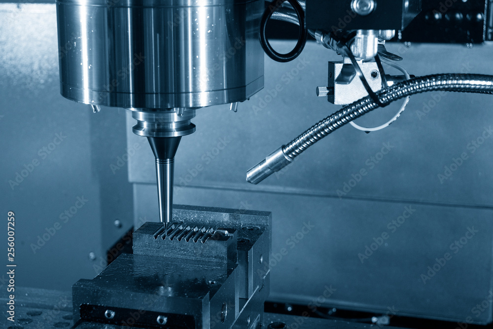 The CNC milling machine cutting the mould part with the solid ball end mill tool.The hi-technology mould and die manufacturing process by CNC machining center. The CNC milling machine cutting the mould part with the solid ball end mill tool.The hi-technology mould and die manufacturing process by CNC machining center.
