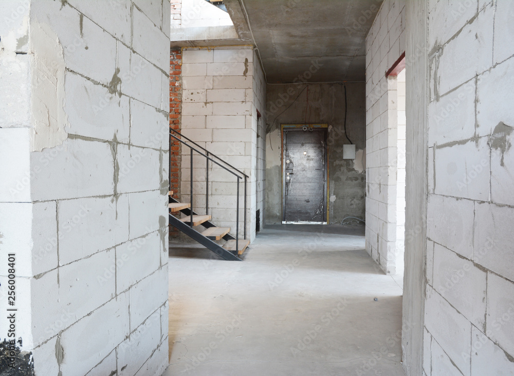 Fototapeta Aerated concrete blocks house corridor walls under construction ready for plastering and stucco