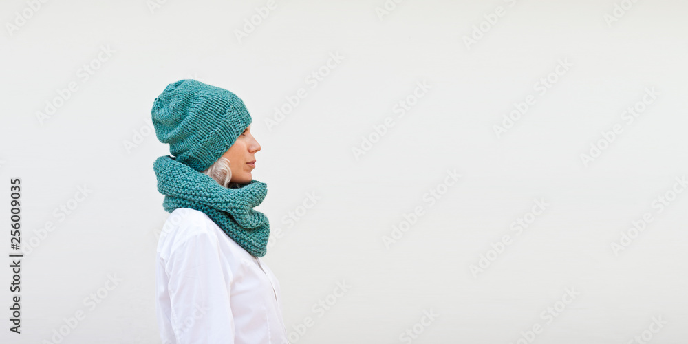 Pretty woman in warm turquoise knitted hat