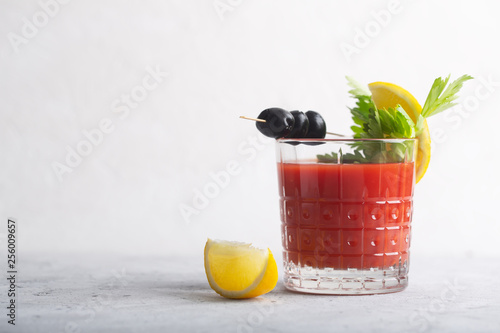 Cocktail Bloody Mary with ice, salt and snacks in glass on a table photo