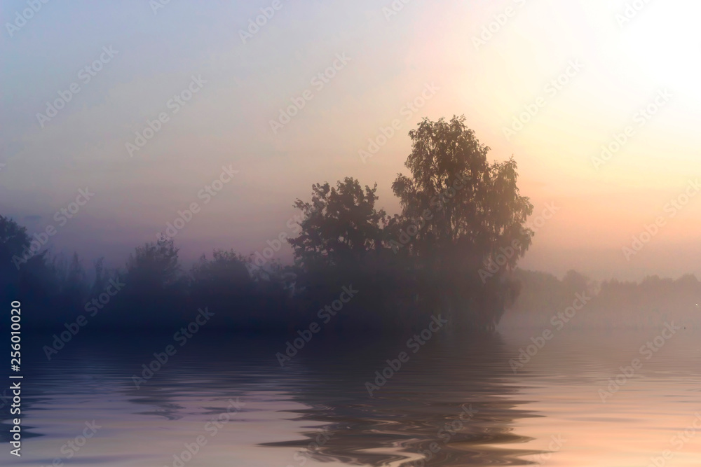 Rural early morning sunrise with lake, fog and russians landscape.