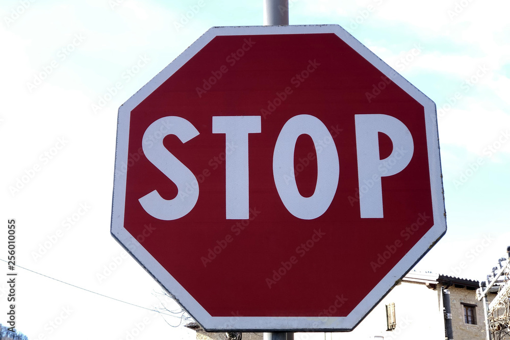 Stop roadsign closeup on background of blue sky