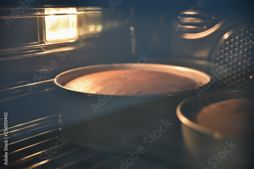 Close up of baking chocolate cakes in the hot oven, homemade cake.