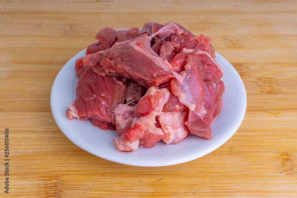 Fresh raw beef steak on wooden background with selective focus Fresh raw beef steak on wooden background with selective focus