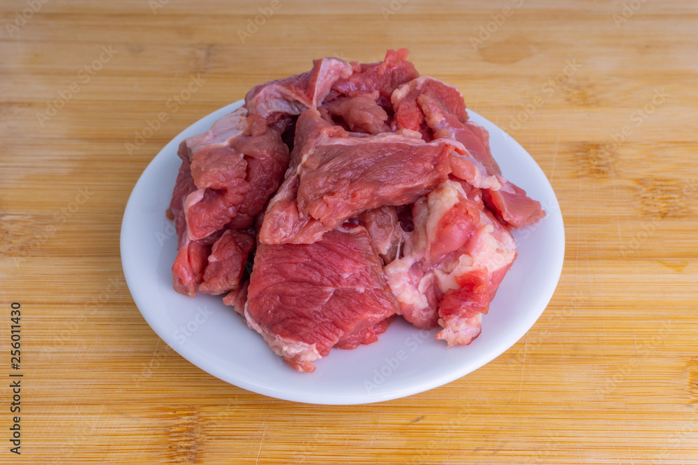 Fresh raw beef steak on wooden background with selective focus Fresh raw beef steak on wooden background with selective focus