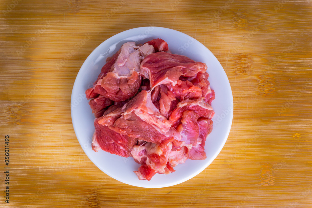 Fresh raw beef steak on wooden background with selective focus Fresh raw beef steak on wooden background with selective focus