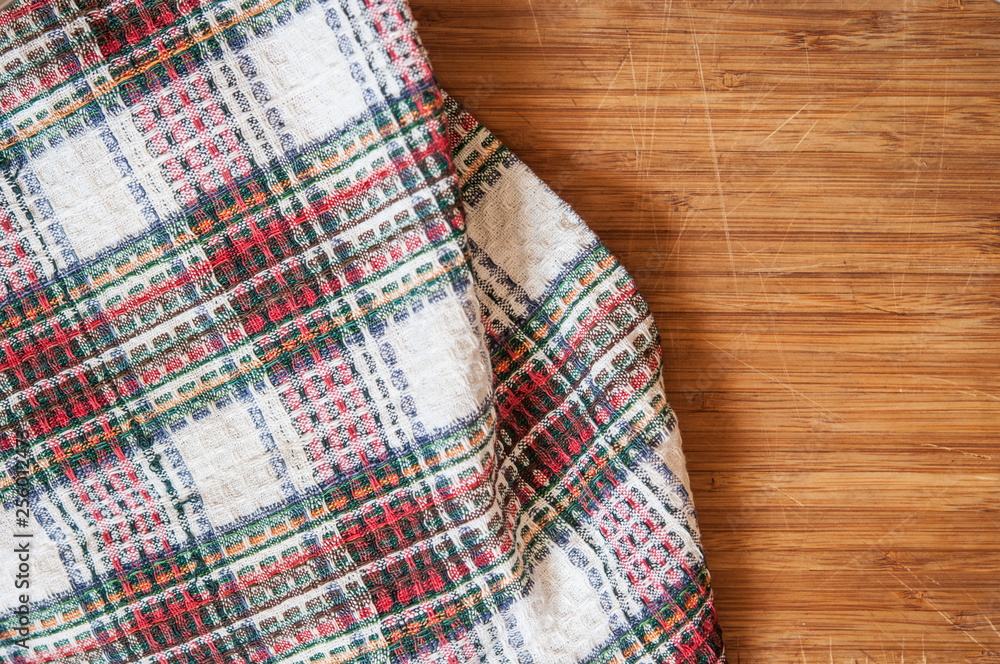 colorful tablecloth on wooden table. Top view colorful tablecloth on wooden table. Top view