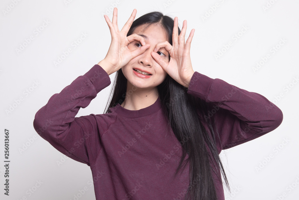 Asian woman do funny double OK sign as glasses. Asian woman do funny double OK sign as glasses.