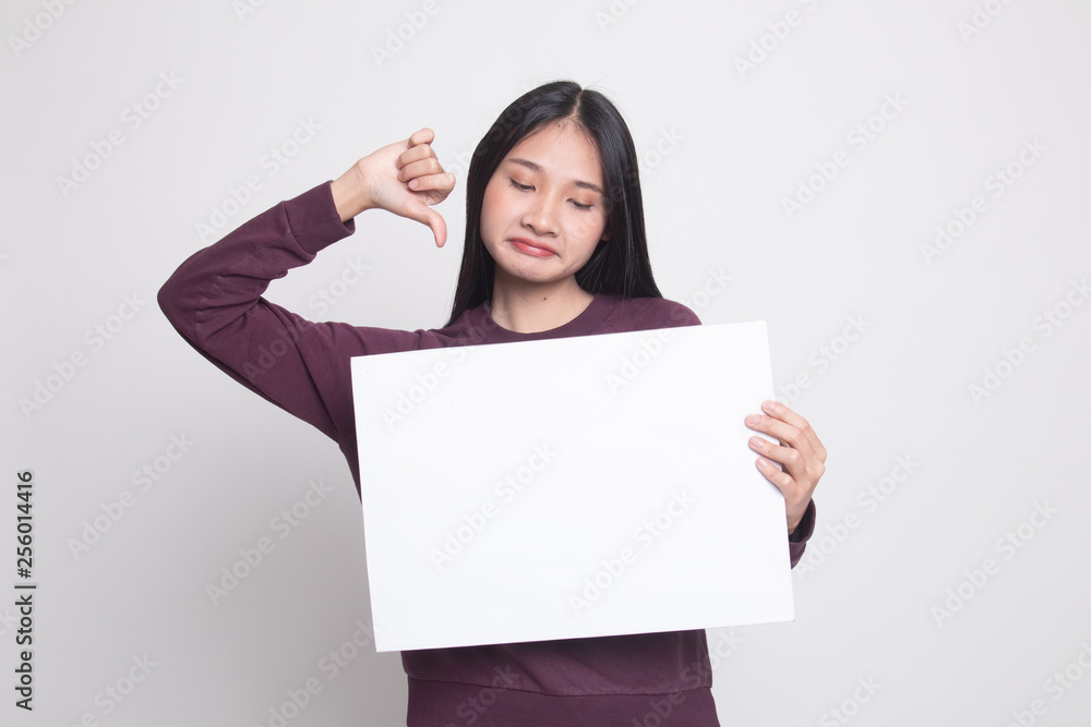 Young Asian woman show thumbs down with white blank sign. Young Asian woman show thumbs down with white blank sign.