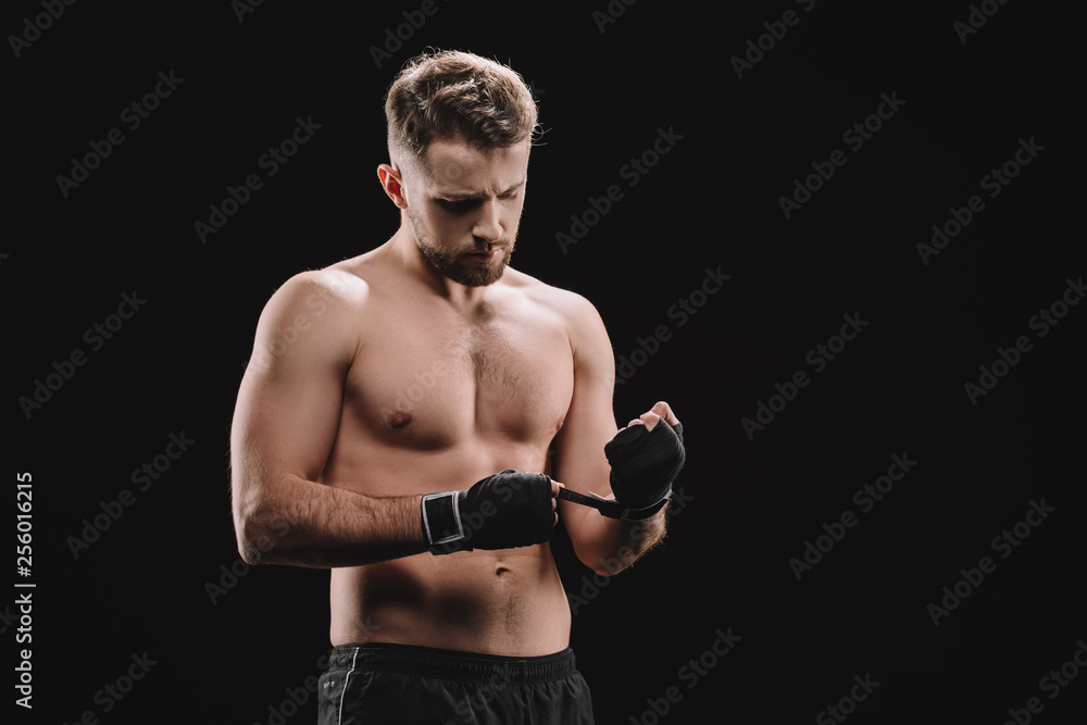 strong muscular mma fighter fixing bandages isolated on black strong muscular mma fighter fixing bandages isolated on black