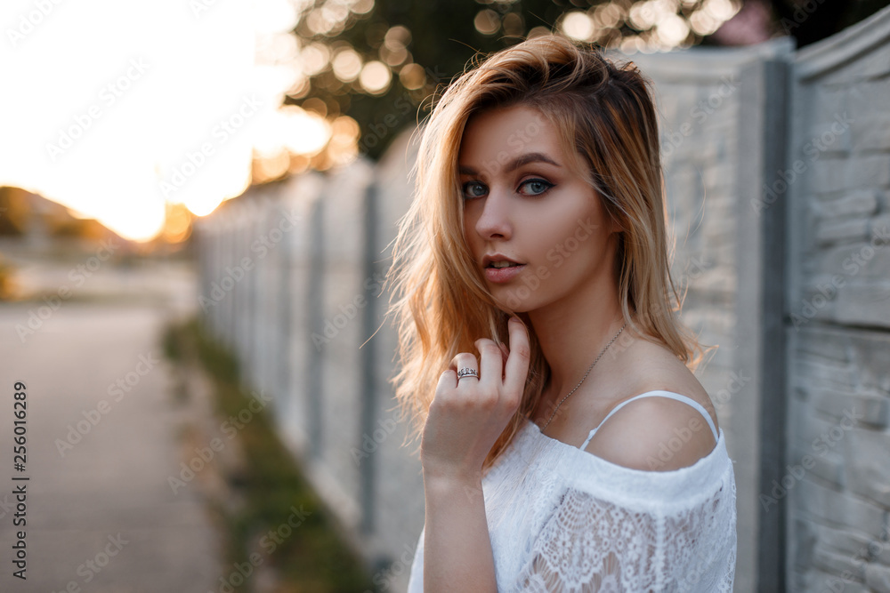 Portrait of a pretty European young blonde woman with blue eyes with  natural make-up in