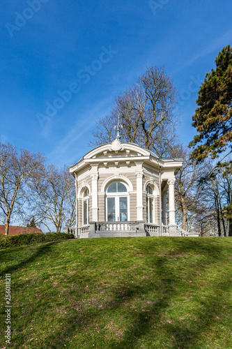 Beautiful view of the Tea dome or Gloriette on a hill with green grass in Proosdij Park, wonderful winter day in Meerssen south Limburg in the Netherlands Holland