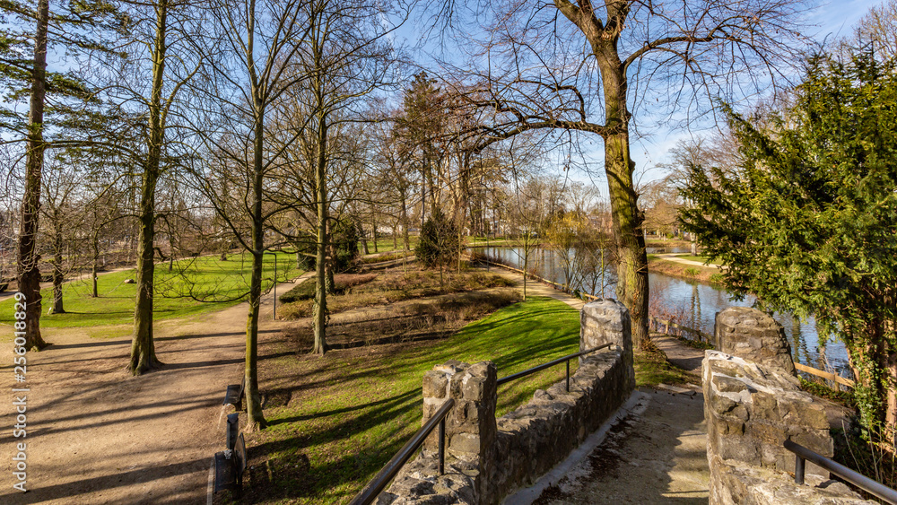 View of the Proosdij Park from a bridge with its trees, river, green grass and trails, wonderful sunny winter day in Meerssen south Limburg in the Netherlands Holland