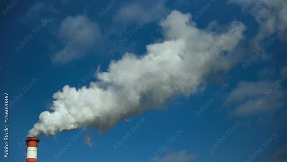 Power plant chimney smoke against cloudy blue sky. Air pollution. High Quality slow motion. Power plant chimney smoke against cloudy blue sky. Air pollution. High Quality slow motion.