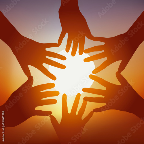 Concept de l’adhésion d’un groupe avec cinq mains tendues devant un coucher de soleil, pour symboliser l’union et la cohésion.