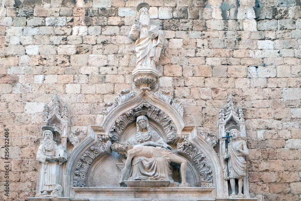 God the Father, Saint Jerome, Our Lady of Sorrow and Saint John the Baptist on the portal of the Franciscan church of the Friars Minor in Dubrovnik, Croatia 