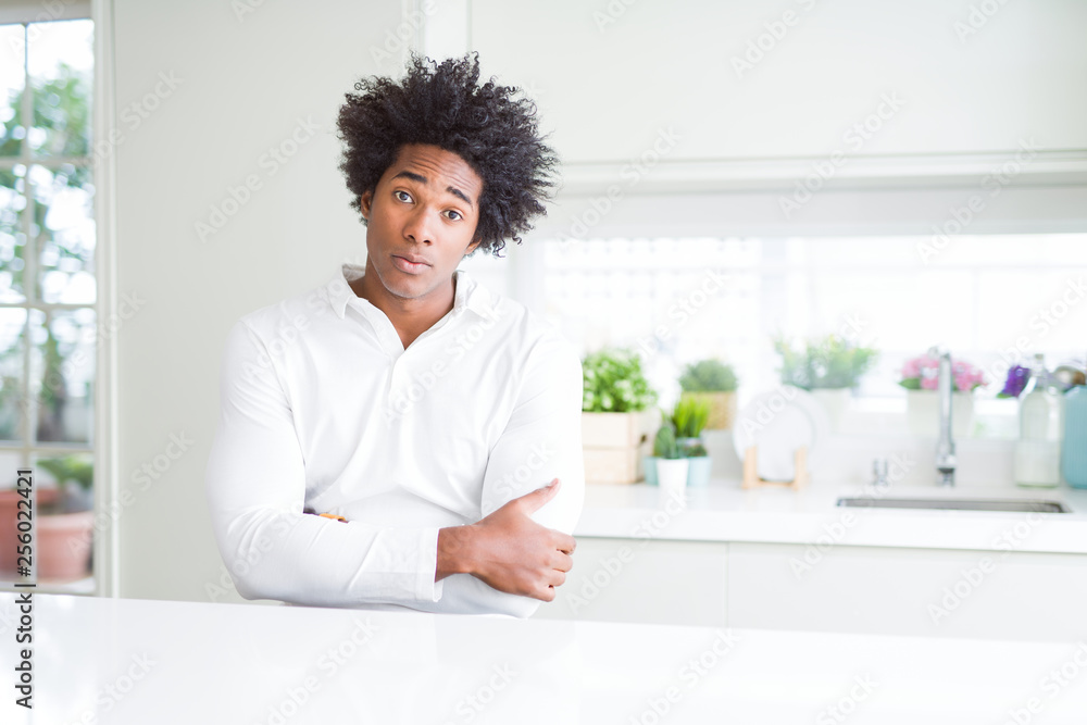 African American man skeptic and nervous, disapproving expression on face with crossed arms. Negative person. African American man skeptic and nervous, disapproving expression on face with crossed arms. Negative person.