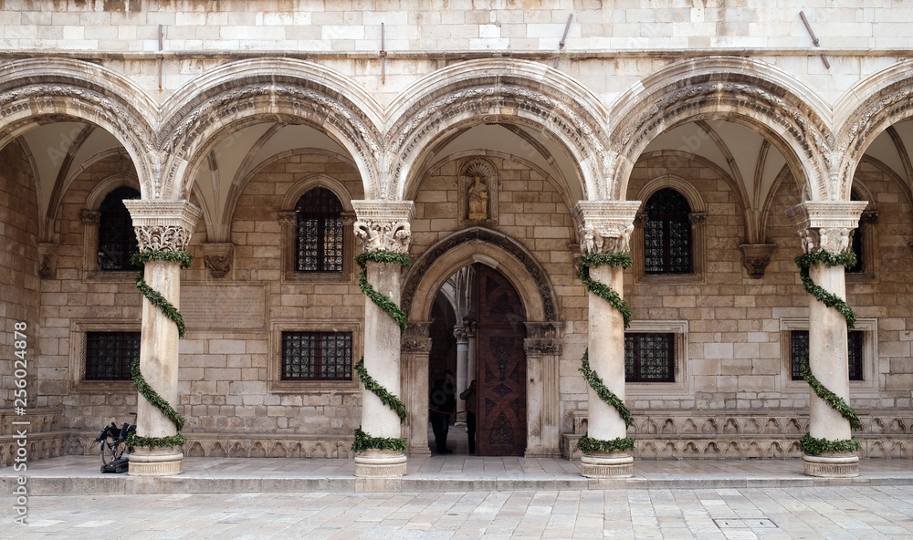 Columns and exterior of the Duke's Palace (Knezev dvor) decorated with Advent wreaths in Dubrovnik, Croatia 
