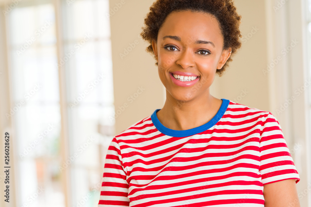 Beautiful young african american woman smiling confident to the camera showing teeth Beautiful young african american woman smiling confident to the camera showing teeth