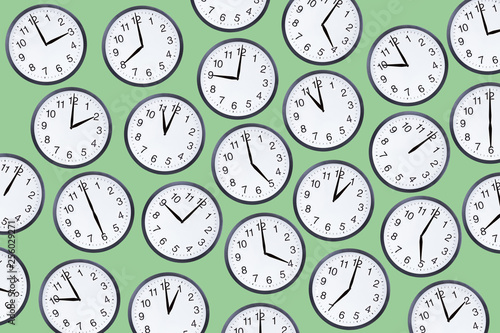 Set of office clocks on green background