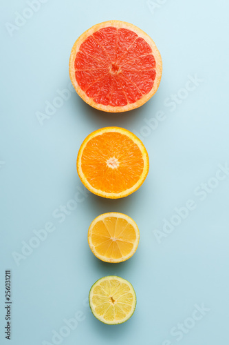 Colorful fruits on blue background in row. Grapefruit, lime, lemon and orange. 