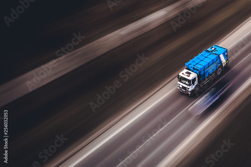 Blue garbage truck vehicle car with high speed on the road