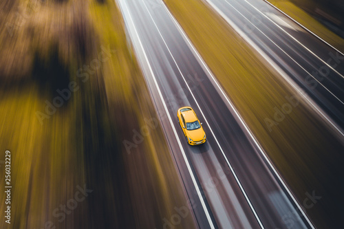 Fast sport car yellow on road street highway movement motion panning