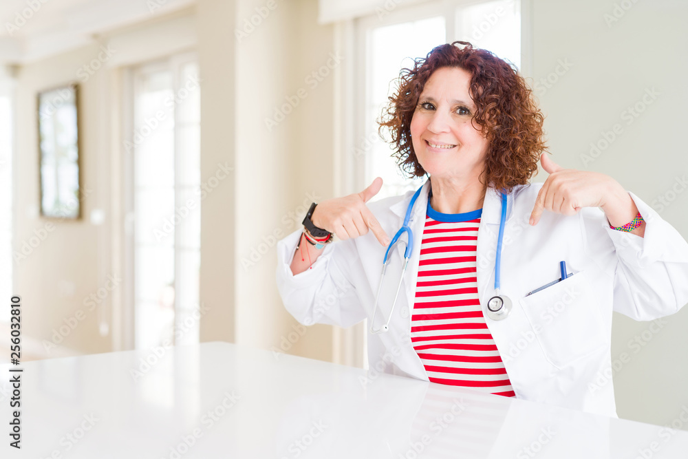 Senior doctor woman wearing medical robe at the clinic looking confident with smile on face, pointing oneself with fingers proud and happy. Senior doctor woman wearing medical robe at the clinic looking confident with smile on face, pointing oneself with fingers proud and happy.