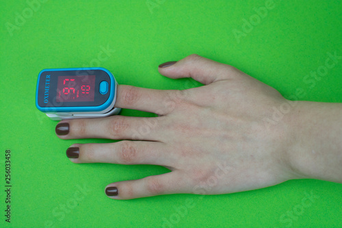 pulse oximeter hand green  background