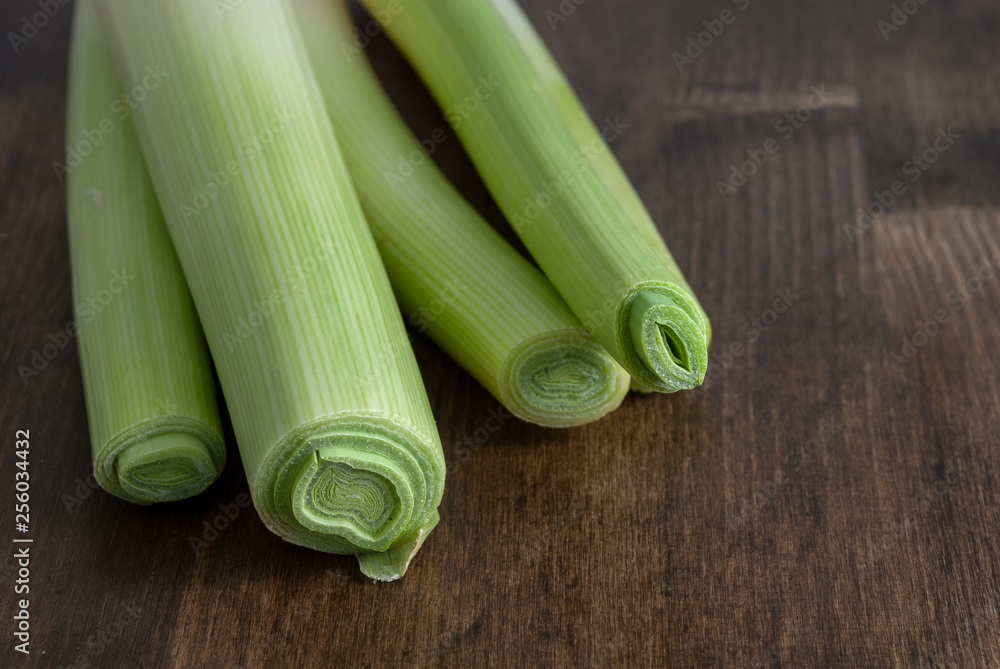 Top view of leeks on dark wood background Top view of leeks on dark wood background
