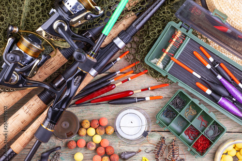 fishing tackle on a wooden table. toned image