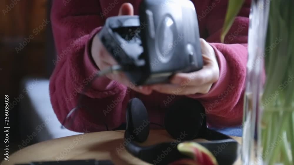 Young girl placing casette tape in walkman. Young girl placing casette tape in walkman.