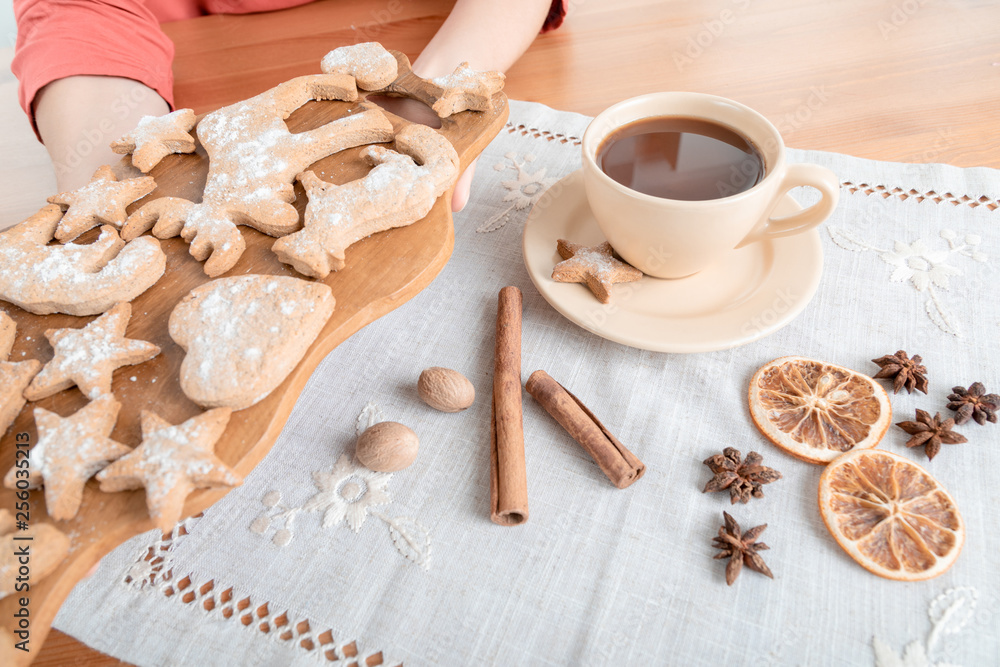 Unrecognizable woman having hot chocolate with ginger cookies for dessert Unrecognizable woman having hot chocolate with ginger cookies for dessert